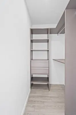 a walk in closet with white walls and shelves at Sublime property in the heart of downtown Miami in Miami