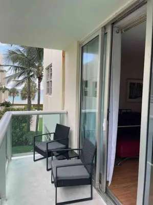 a balcony with two chairs and a table at Lovely 2 bedroom with side ocean view in Hollywood