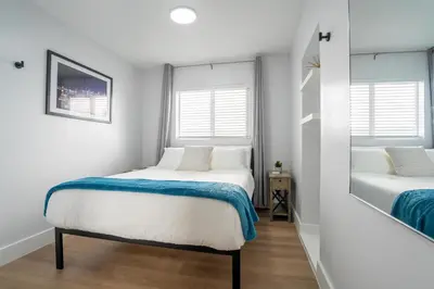 a bedroom with two beds and two windows at 5BR HotTubPoolTableMiniGolf 7 min to Wynwood in Miami