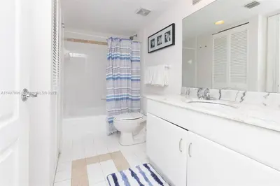 a white bathroom with a toilet and a sink at Entire Condo in Brickell steps from Brickell City Centre in Miami