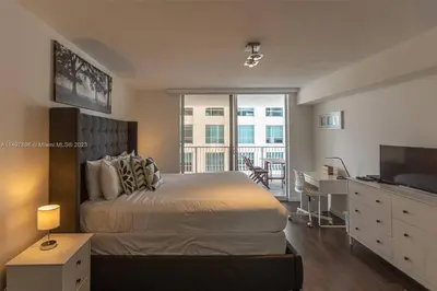a bedroom with a bed and a desk and a television at Entire Condo in Brickell steps from Brickell City Centre in Miami