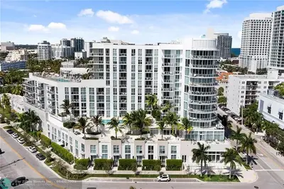 an aerial view of a large white building with palm trees at The Glamour of Upscale Downtown Ft. Lauderdale in Fort Lauderdale