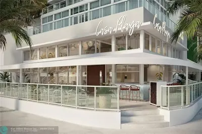 a large building with tables and chairs in front of it at The Glamour of Upscale Downtown Ft. Lauderdale in Fort Lauderdale