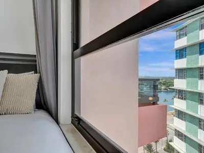 a bedroom with a bed and a window with a view at Cozy Beachfront 2 BDR Miami Beach Condo 1516 in Miami Beach