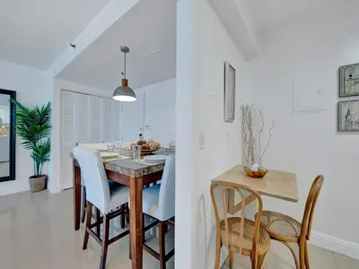 a kitchen and dining room with a table and chairs at Cozy Beachfront 2 BDR Miami Beach Condo 1516 in Miami Beach