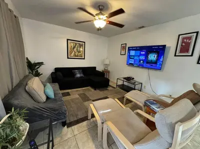 a living room with a couch and a flat screen tv at 2 Bedroom Boutique Gem 10 min to the beach Washer Dryer Gated Parking Bliss 2 in Hollywood