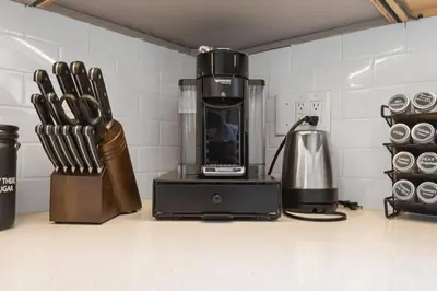 a kitchen counter with a coffee maker and a blender at Modern Tropical Pool House North Miami Hot Tub in Miami