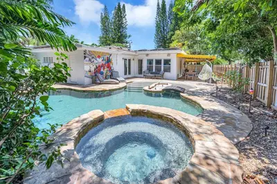 a swimming pool in a backyard with a house at Modern Tropical Pool House North Miami Hot Tub in Miami