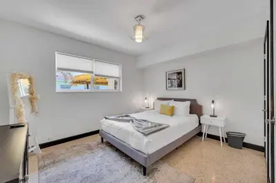 a white bedroom with a bed and a window at Modern Tropical Pool House North Miami Hot Tub in Miami