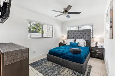 a bedroom with a bed and a ceiling fan at Miami Oasis, Spacious 4-Bedroom Home with Pool in Miami