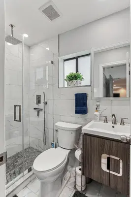 a bathroom with a toilet and a sink and a shower at Miami Oasis, Spacious 4-Bedroom Home with Pool in Miami