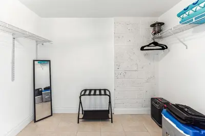 a room with a mirror and a chair in it at Miami Oasis, Spacious 4-Bedroom Home with Pool in Miami