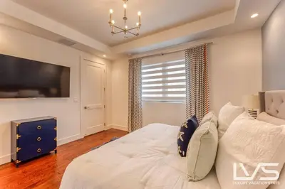 a bedroom with a large white bed and a window at Victoria Villa - Walk to Las Olas - 4 Bed 4 Bath in Fort Lauderdale
