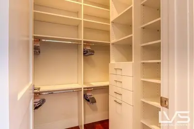 a walk in closet with white cabinets and drawers at Victoria Villa - Walk to Las Olas - 4 Bed 4 Bath in Fort Lauderdale