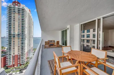 a balcony with a table and chairs and a view of the ocean at Sublime 1 BED 1 BTH • Brickell BAY & CITY VIEW in Miami