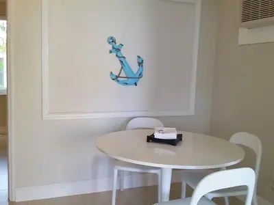 a white table and chairs in a room with a table at Hollywood Broadwalk Oceanside Hotel in Hollywood