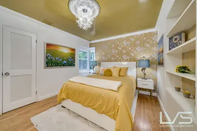 a bedroom with a bed and a chandelier at Floridita 5Bed 4Bath FTL Paradise with Tiki Hut Heated Pool in Fort Lauderdale