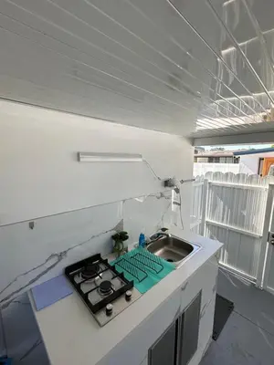 a small kitchen with a sink and a stove at Adrien Guest Studio in Miami Gardens
