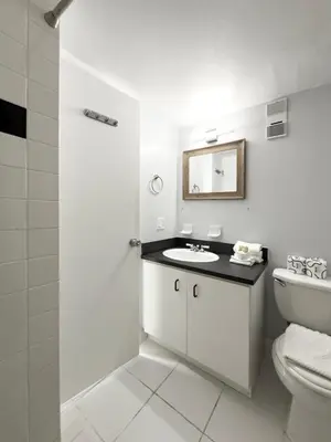 a white bathroom with a sink and a toilet at Art Deco Washingthon Apartment in Miami Beach