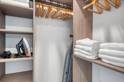 a walk in closet with wooden shelves and towels at Blueground Wynwood gym roof pool nr Midtown MIA-101 in Miami
