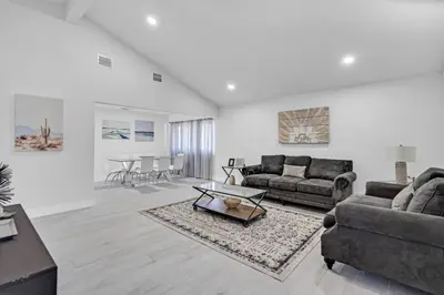 a living room with a couch and a table at Chic Miami Private Pool Home in Cutler Ridge
