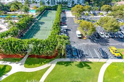 an aerial view of a parking lot with tennis courts at Cozy newly furnished apartment , on the 6th floor. in Sunny Isles Beach
