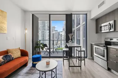 a living room with a couch and a table at Breezy Stays Luxury Residences - near Kaseya Center in Miami