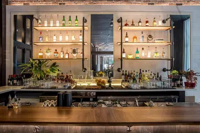 a bar with a lot of bottles of alcohol at Breezy Stays Luxury Residences - near Kaseya Center in Miami