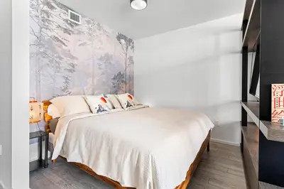 a bedroom with a bed and a wall mural at Breezy Stays Luxury Residences - near Kaseya Center in Miami