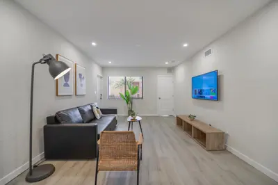 a living room with a couch and a tv on a wall at Prime Location Apartment at Calle Ocho in Miami