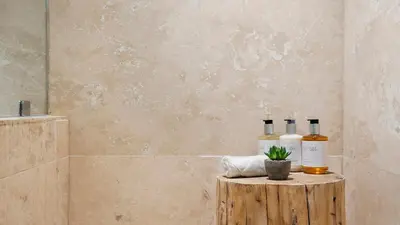 a bathroom with three bottles of wine on a wooden stump at Luxurious Private Condo at 1 Hotel & Homes - 1545 in Miami Beach