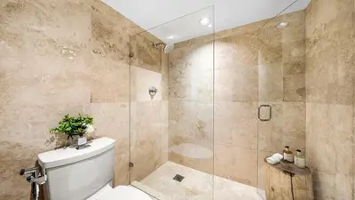 a bathroom with a toilet and a glass shower at Luxurious Private Condo at 1 Hotel & Homes - 1545 in Miami Beach