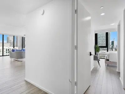 a white room with a view of a bedroom and a bed at X Lounge IV-Skyline Corner Residence in Miami