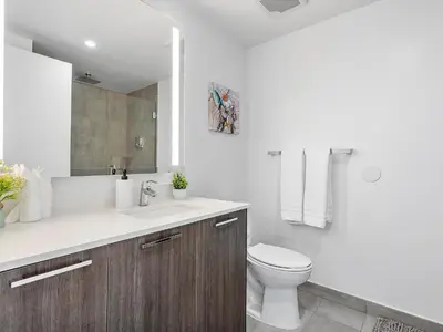 a white bathroom with a toilet and a sink at X Lounge IV-Skyline Corner Residence in Miami