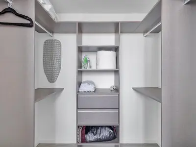 a walk in closet with white walls and shelves at X Lounge IV-Skyline Corner Residence in Miami
