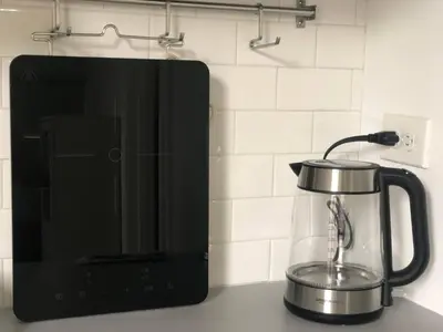 a tea kettle on a counter next to a blender at Cozy Studio Apartment in Miami