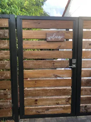 a wooden gate with a sign on it at Cozy Studio Apartment in Miami