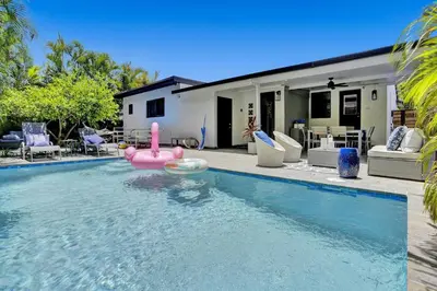 a swimming pool with a pink flamingo in a house at Casa Coral with Pool Charcoal BBQ area in Miami