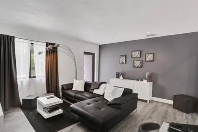 a living room with a couch and a table at Casa Coral with Pool Charcoal BBQ area in Miami