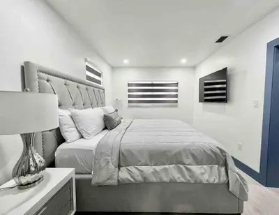 a bedroom with a large bed and a couch at Renovated Grand Villa Paradise Amazing pool, BBQ & Ping Pong in Tamiami