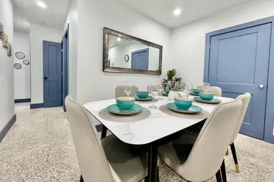 a dining room with a white table and chairs at Renovated Grand Villa Paradise Amazing pool, BBQ & Ping Pong in Tamiami