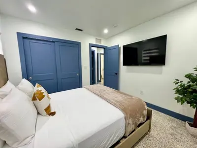 a bedroom with a bed with blue doors and a tv at Miami dream resort heated pool sleeps 8 in Tamiami