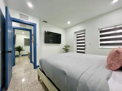 a bedroom with a large bed and a tv at Miami dream resort heated pool sleeps 8 in Tamiami