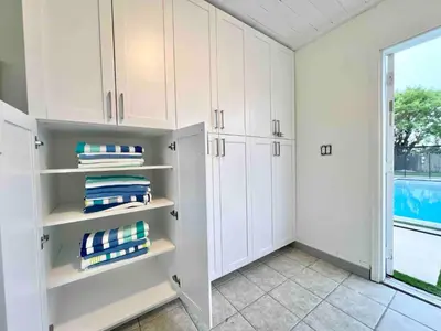 a white laundry room with white cabinets and a window at Miami dream resort heated pool sleeps 8 in Tamiami
