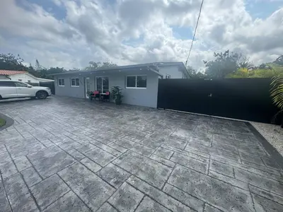 a house with a car parked in front of it at Miami dream resort heated pool sleeps 8 in Tamiami