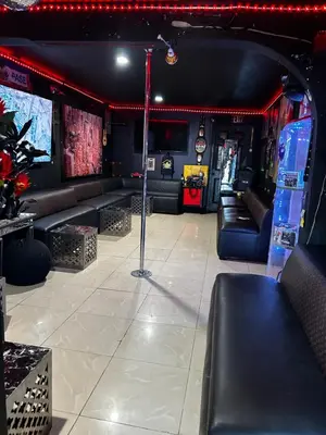 a room with couches and tables and an umbrella at The Black Door miami in Miami