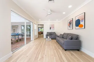a living room with a couch and a ceiling fan at Tropical Waterfront Family Oasis - Amazing Location in Miami