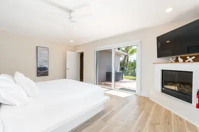 a bedroom with a white bed and a fireplace at Tropical Waterfront Family Oasis - Amazing Location in Miami