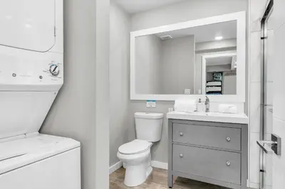 a white bathroom with a toilet and a sink at Tropical Waterfront Family Oasis - Amazing Location in Miami