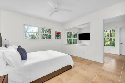 a white bedroom with a large bed and windows at Tropical Waterfront Family Oasis - Amazing Location in Miami